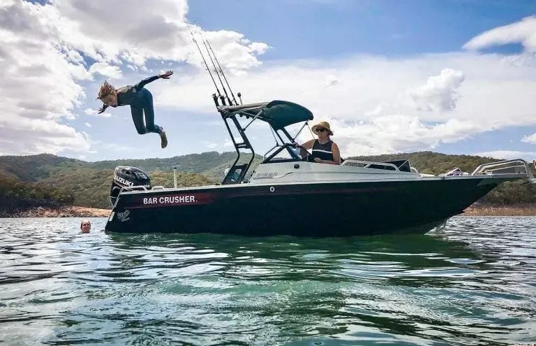 Man leaping into water from a BR-Series boat 